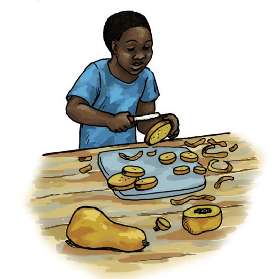 A boy cutting a butternut.