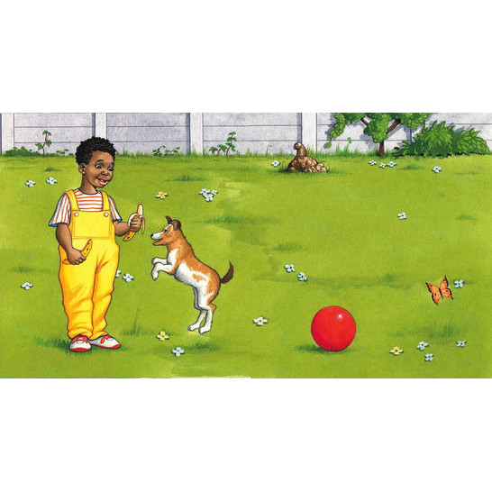 A boy holding a banana in each hand and a dog jumping up.